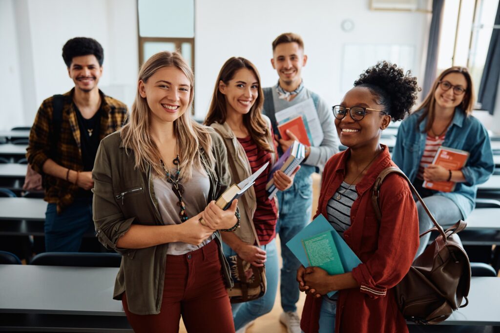 multi ethnic group of university students in lecture hall looking at camera