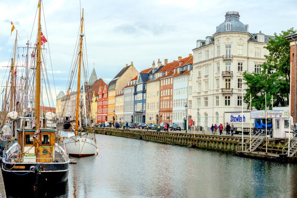 scenic river view of vibrant buildings and boats in copenhagen denmark